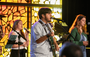 Male student singing in Chapel